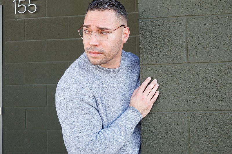 Brand photography image of man wearing fashionable eyeglasses and a sweater